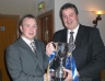 Antrim Chairman Jim Murray presents Team Captain Thomas Doherty the Antrim Intermediate Football Championship trophy